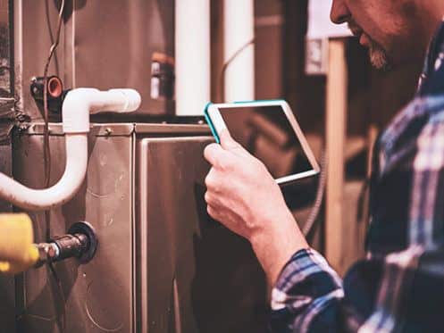 HVAC tech installing a furnace